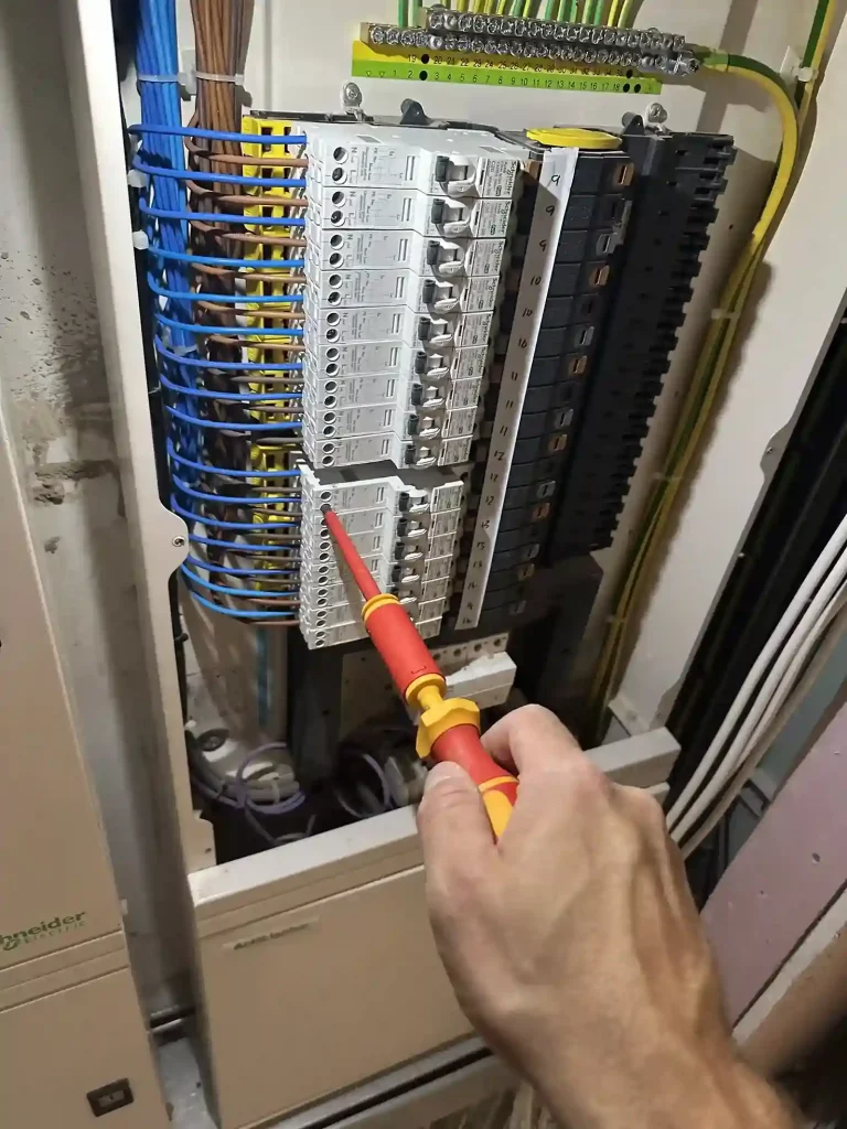 Electrical Distribution Board—Maintenance in Progress with Insulated Screwdriver