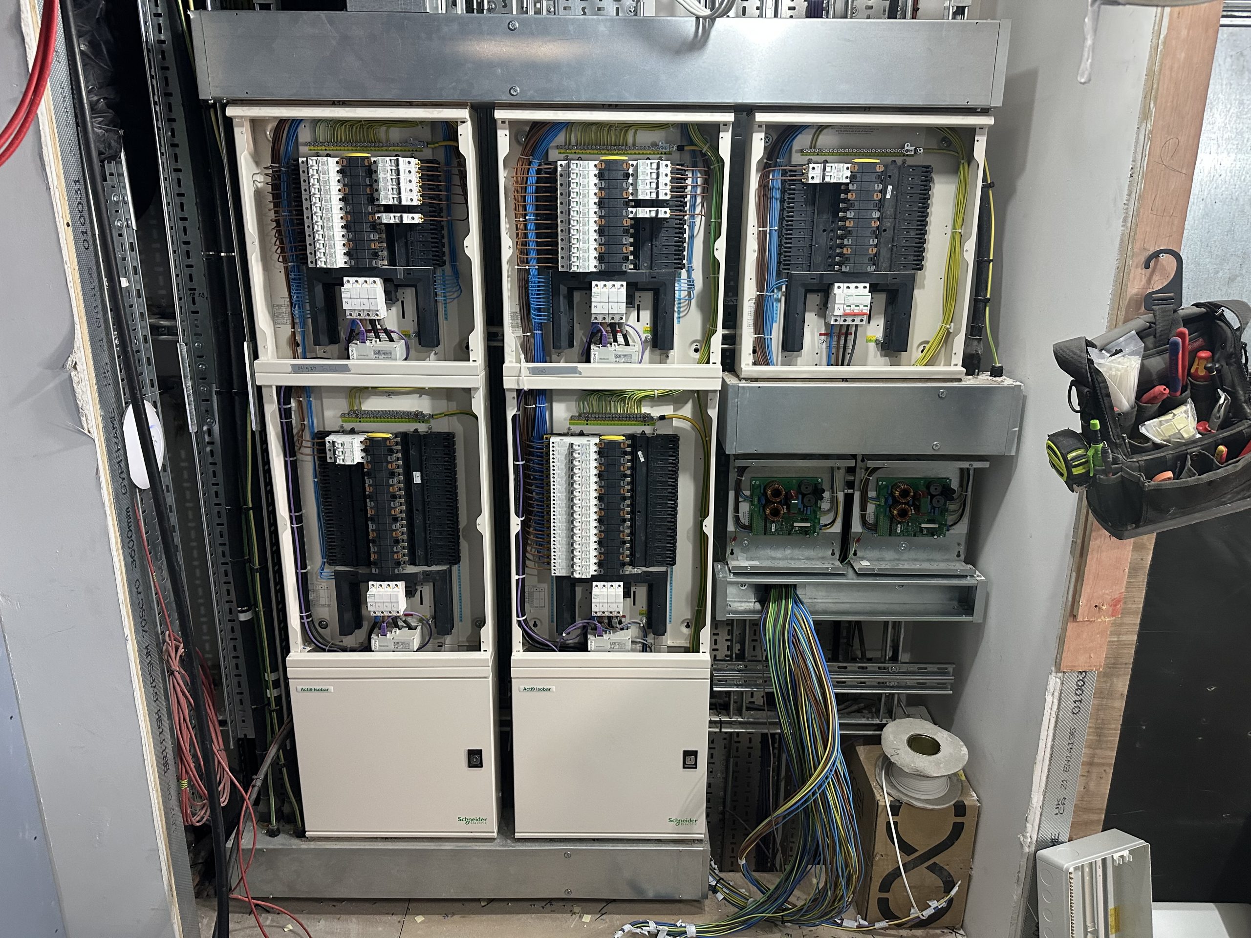 Commercial three-phase Schneider distribution boards installed with organised circuit wiring and containment