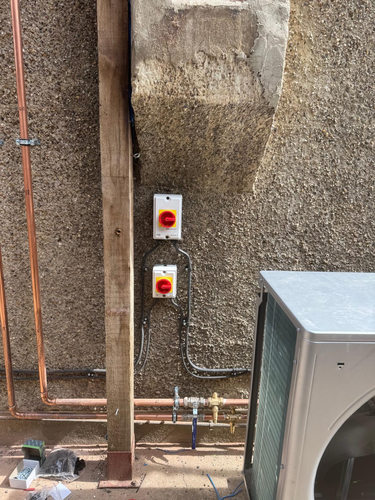 Electrical isolators and dedicated supplies installed for an air-source heat pump