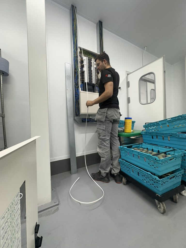 ZJ electrician working on a commercial electrical distribution board