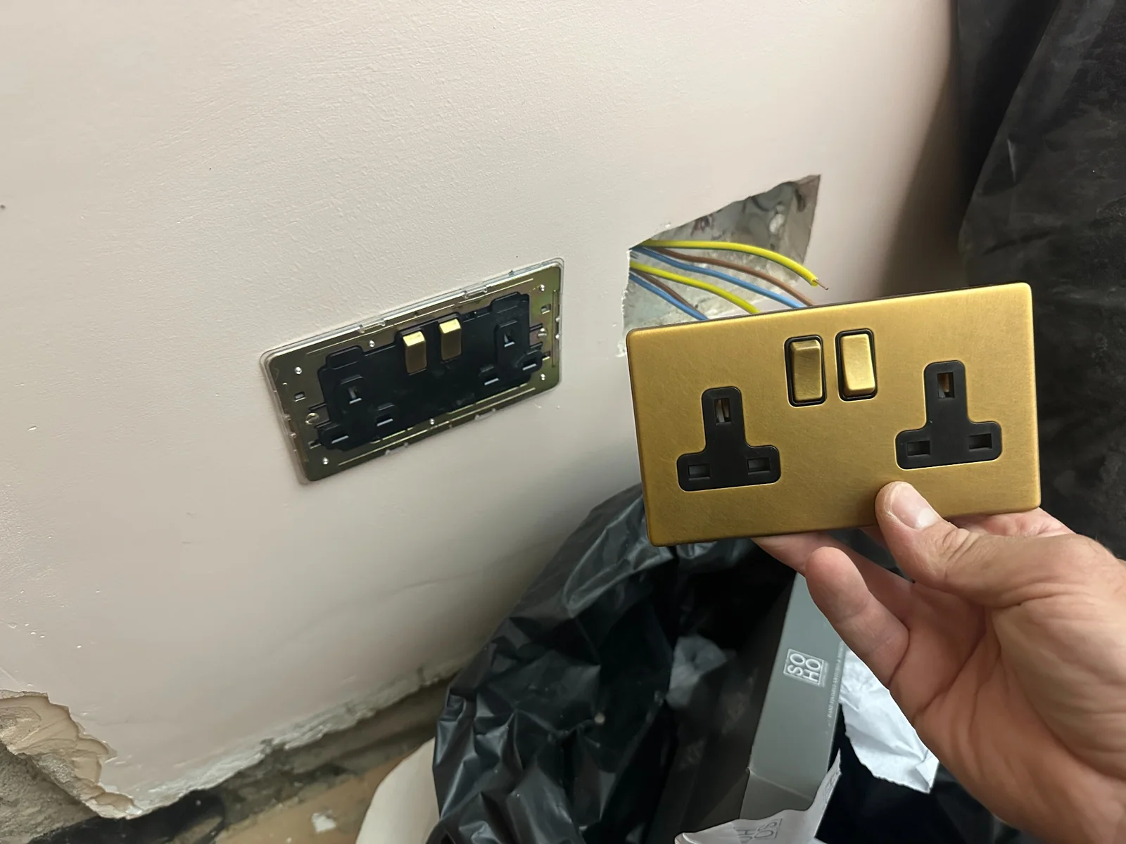 Brass Double Socket Installation Brass double socket accessory being fitted during electrical installation work