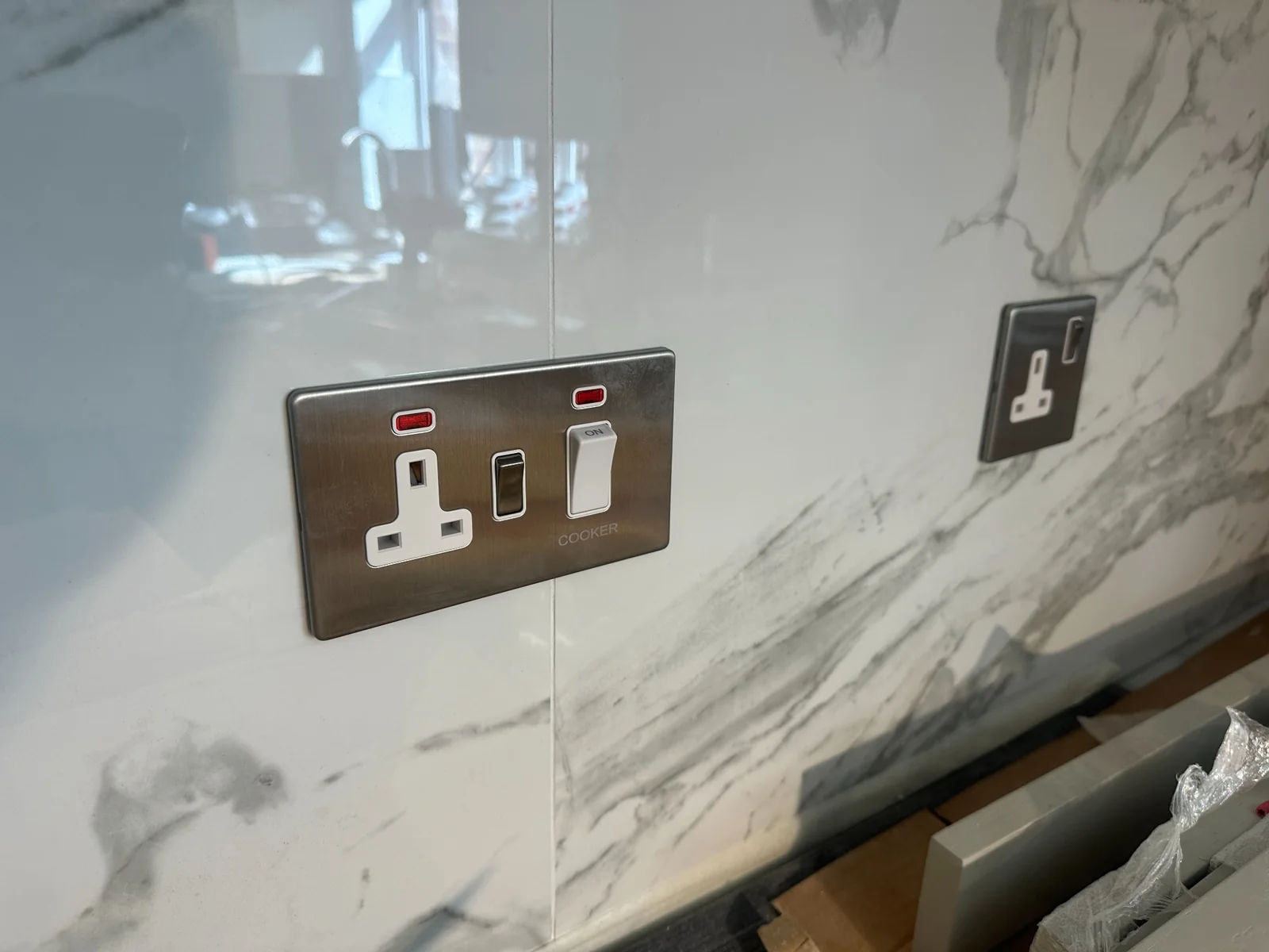 Kitchen Cooker Switch and Socket Installation Cooker switch and socket outlets installed on a tiled kitchen splashback