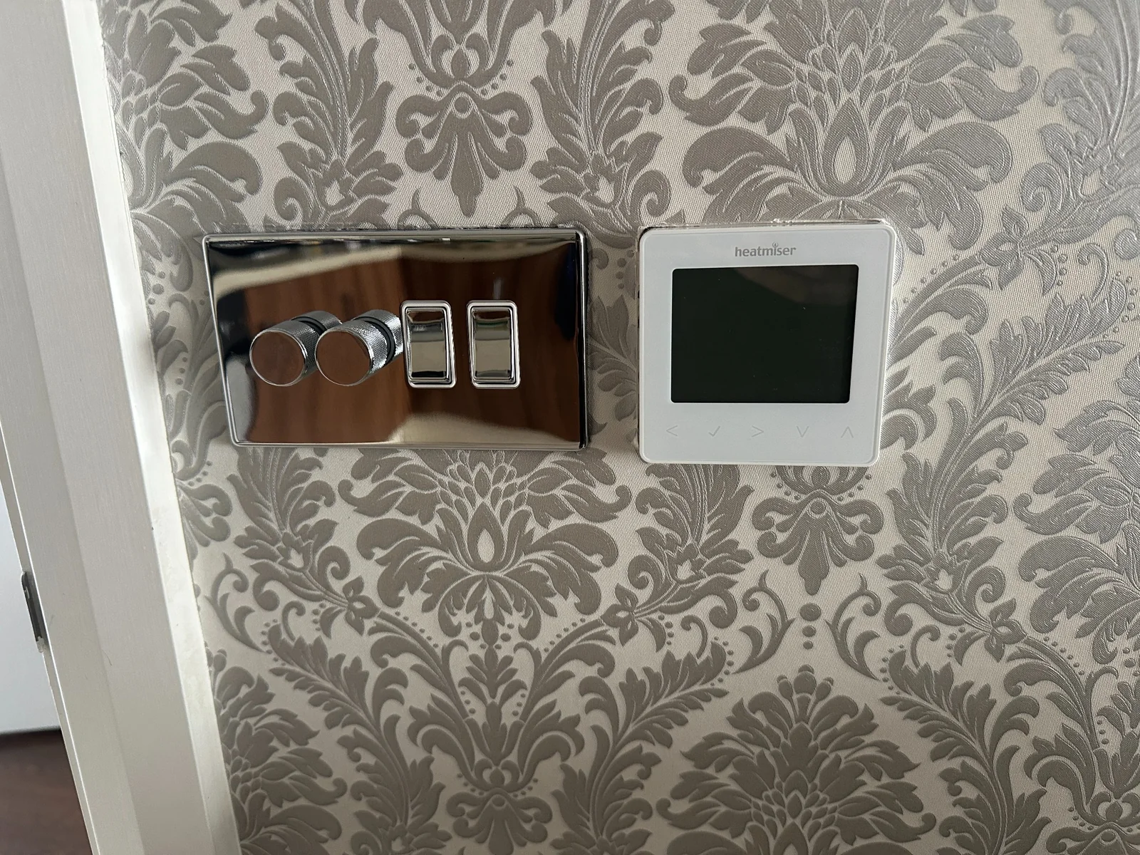 Lighting Controls and Thermostat Installation Wall-mounted lighting controls and Heatmiser thermostat installed side by side